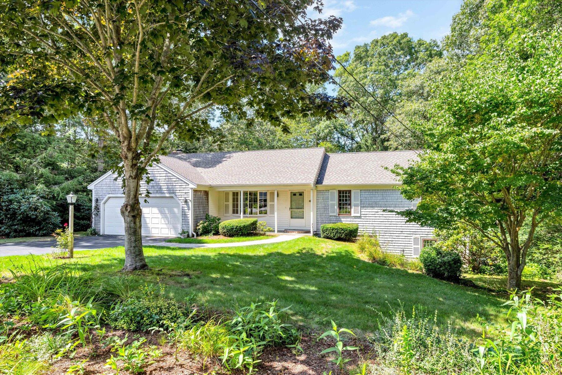 97 Headwaters Road Centerville, MA 02632 - Photo 3 of 44 a front view of a house with garden