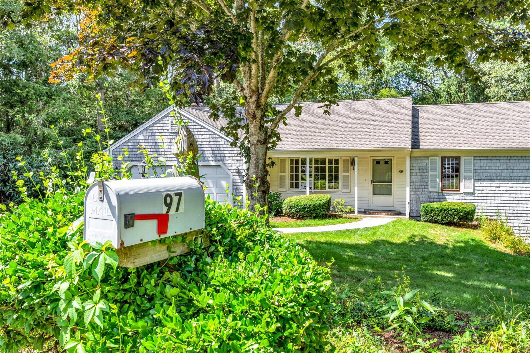 97 Headwaters Road Centerville, MA 02632 - Photo 32 of 44 a front view of a house with yard and green space