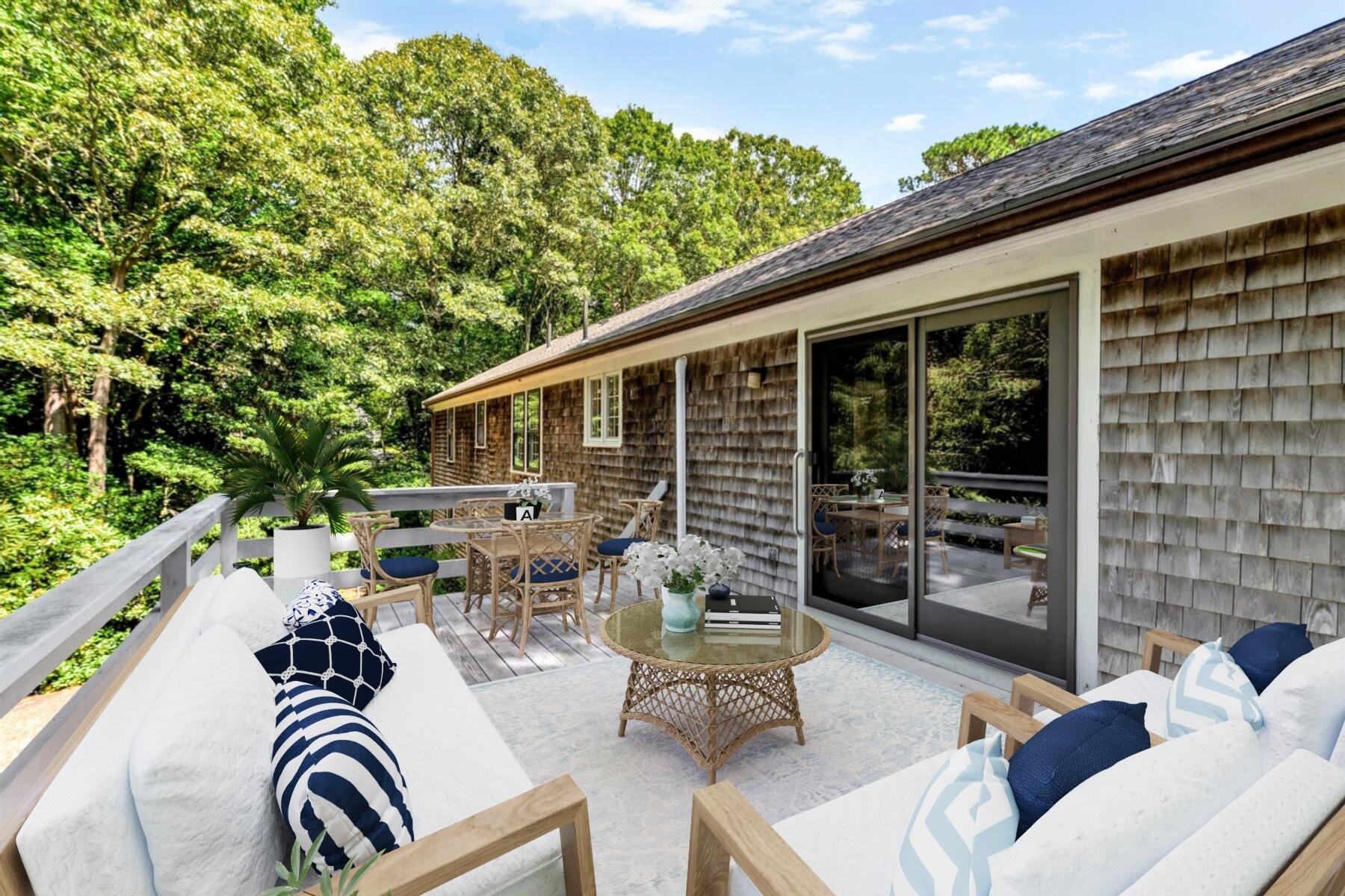 97 Headwaters Road Centerville, MA 02632 - Photo 34 of 44 a view of a patio with couches table and chairs and potted plants