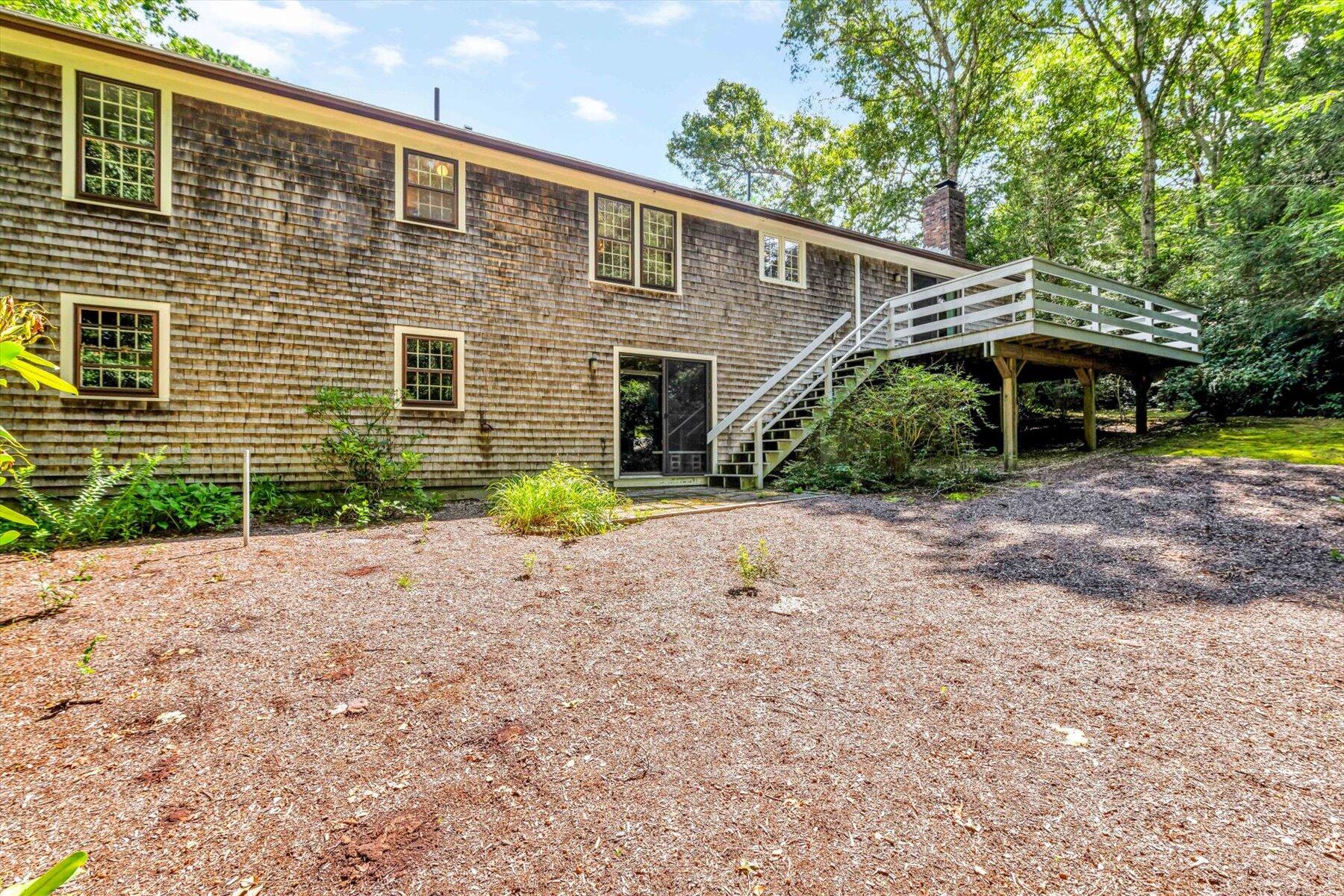 97 Headwaters Road Centerville, MA 02632 - Photo 38 of 44 a front view of a house with a yard