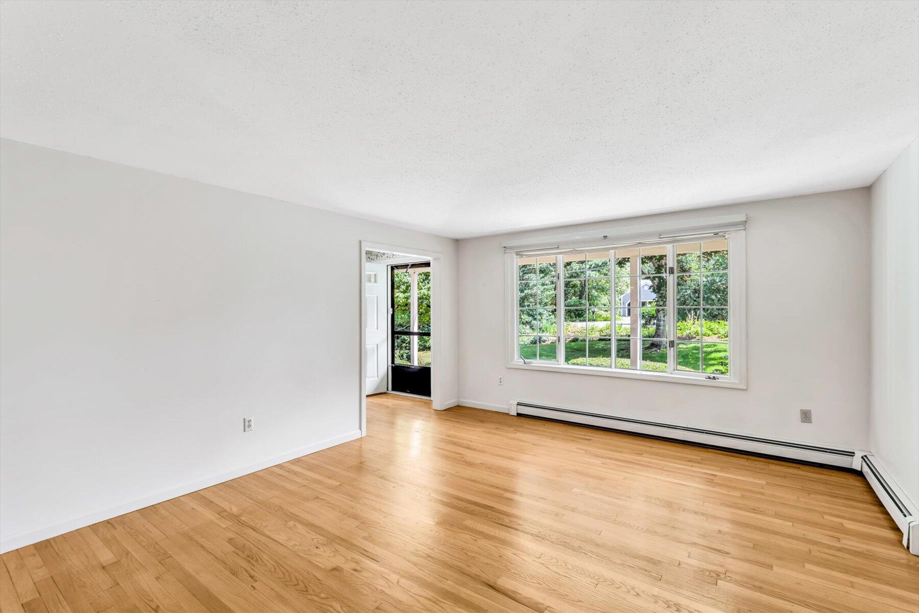 97 Headwaters Road Centerville, MA 02632 - Photo 5 of 44 an empty room with wooden floor and windows