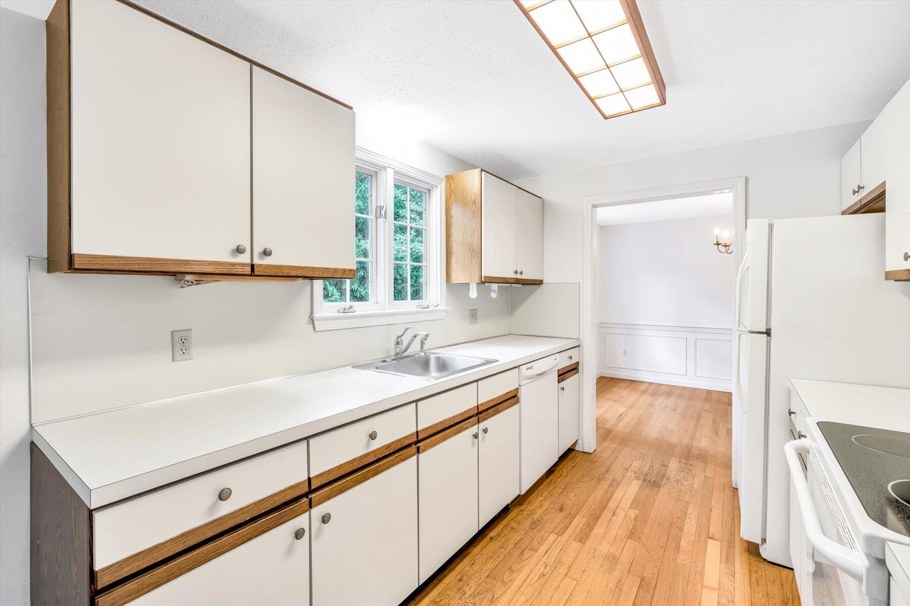97 Headwaters Road Centerville, MA 02632 - Photo 9 of 44 a kitchen with a sink and a wooden floor