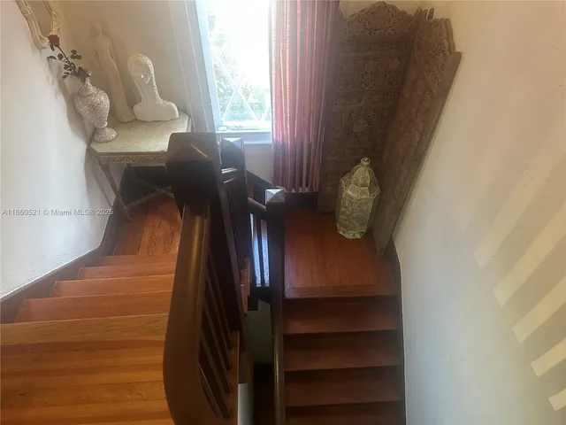 a view of a chairs and table in the backyard