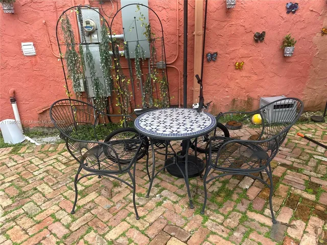 a view of swimming pool with outdoor seating and plants