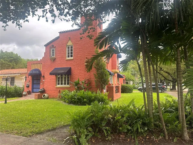 a view of a house with a yard and tree s