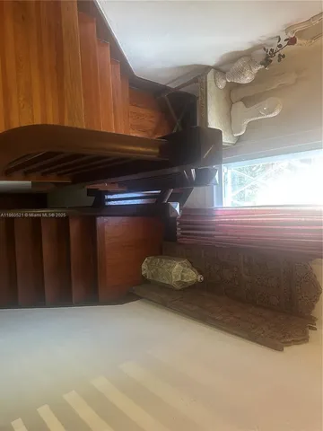 a walk in closet with wooden floor