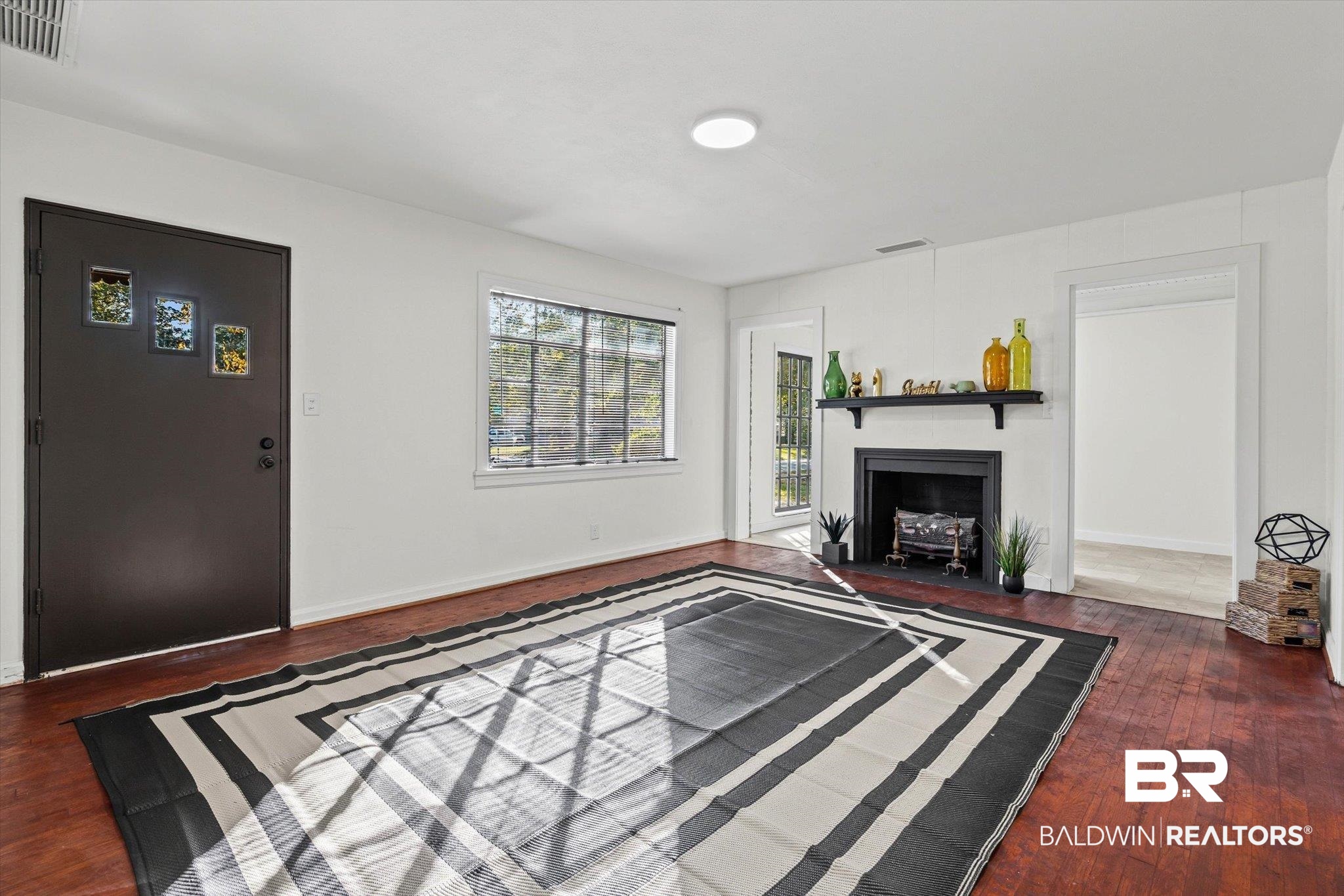 2806 Exter Drive Mobile, AL 36606 - Photo 3 of 24 Unfurnished living room with dark wood finished floors and a fireplace with flush hearth