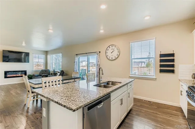 a kitchen with a table chairs a stove a dining table and chairs