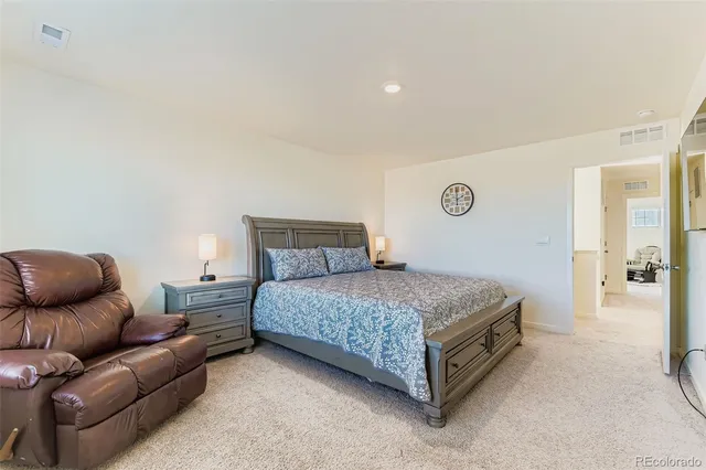 a bedroom with a bed and a couch