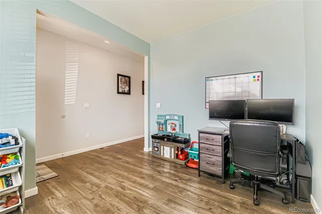 a livingroom with workspace and a couch