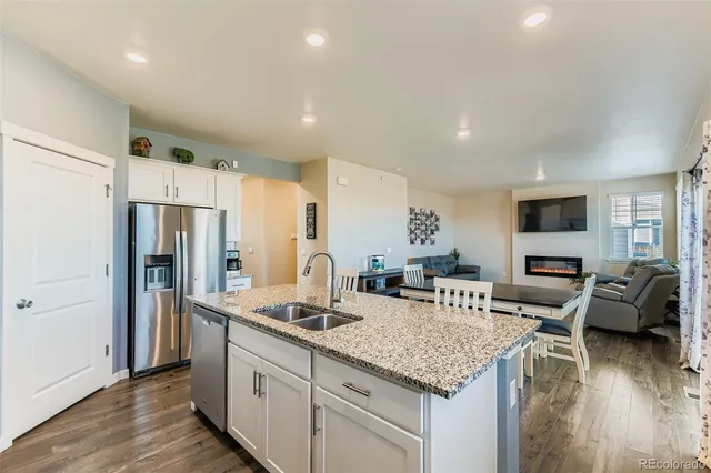 a kitchen with stainless steel appliances granite countertop a refrigerator stove microwave and sink
