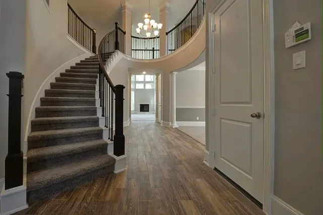 a view of entryway and hall with wooden floor