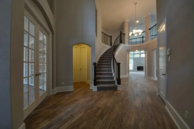 a view of entryway and hall with wooden floor
