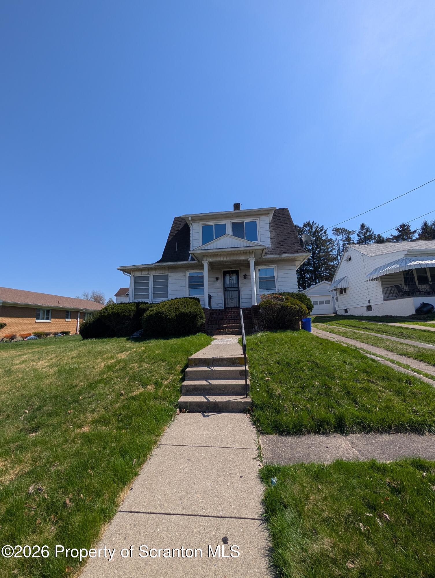 2307 Prospect Avenue Scranton, PA 18505 - Photo 2 of 11 a front view of a house with a yard