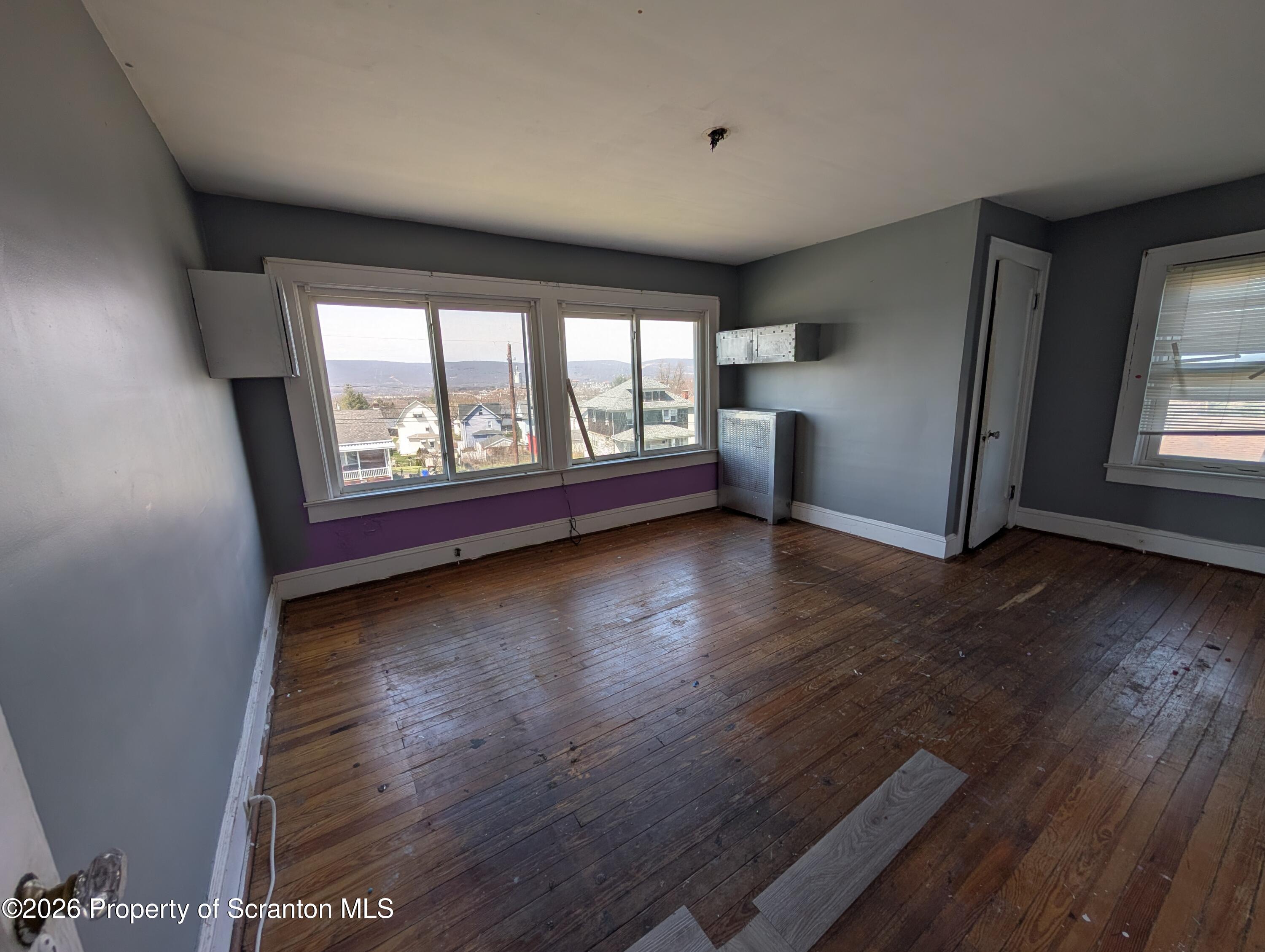 2307 Prospect Avenue Scranton, PA 18505 - Photo 3 of 11 an empty room with wooden floor and windows