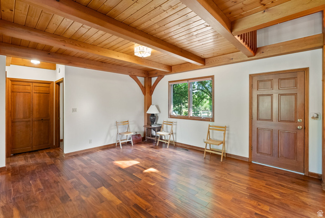 435 Canyon Road Millville, UT 84326 - Photo 15 of 113 Expansive wood-finish flooring offering a warm ambiance, complemented by exposed wood beams and a paneled wood ceiling