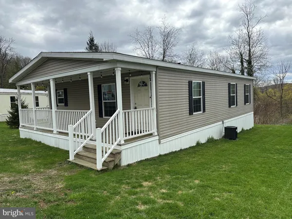 a view of a house with a yard and deck