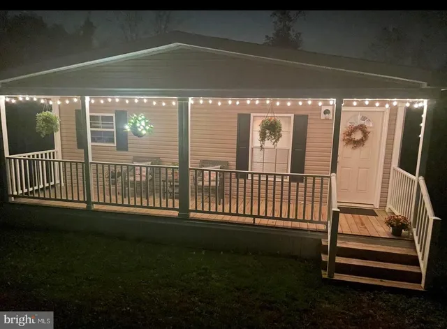 a view of a porch with a floor to ceiling window and stairs
