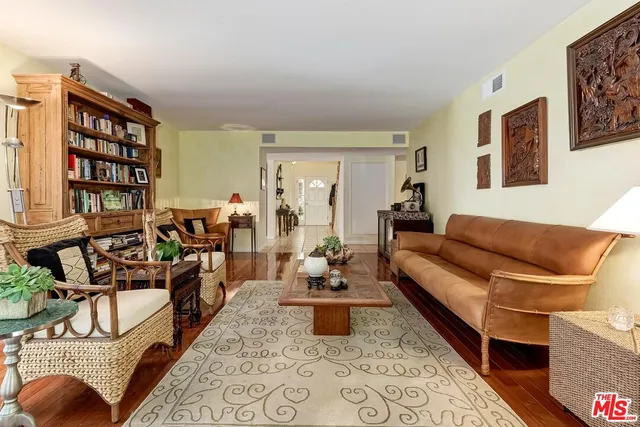 a living room with furniture and a book shelf