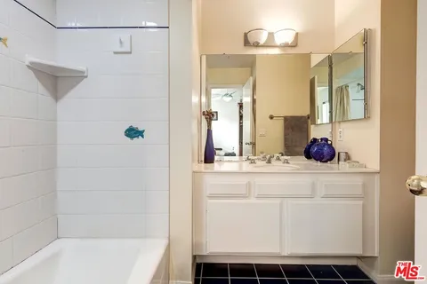 a bathroom with a shower and a sink