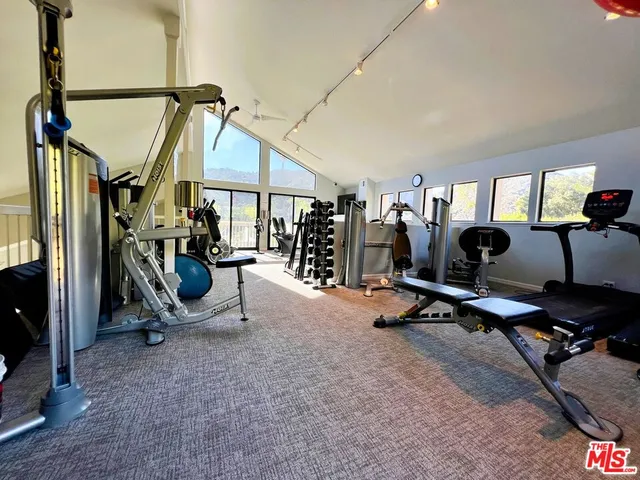 a living room with furniture a flat screen tv and a large window