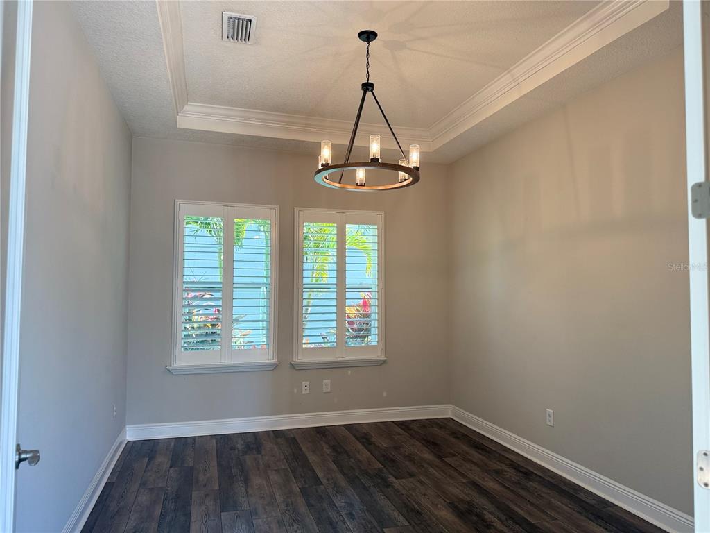 7004 Mainland Avenue Apollo Beach, FL 33572 - Photo 13 of 67 a view of a room with wooden floor exposed radiator and a window