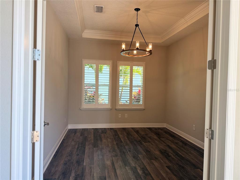 7004 Mainland Avenue Apollo Beach, FL 33572 - Photo 14 of 67 a view of empty room with wooden floor and window