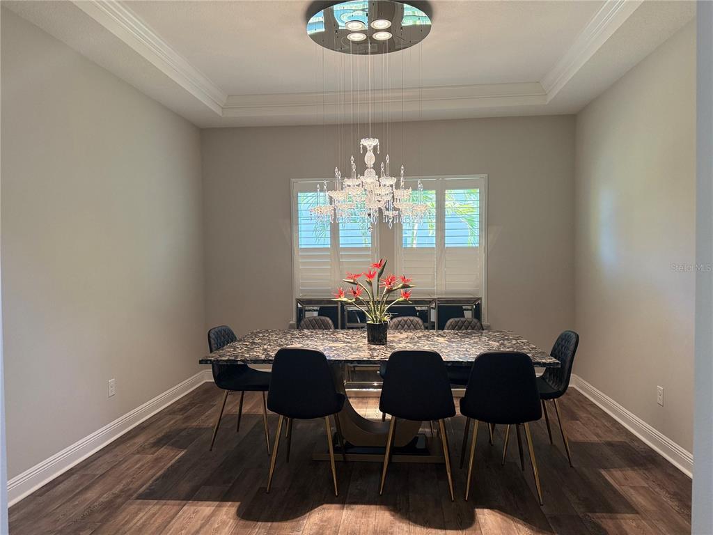 7004 Mainland Avenue Apollo Beach, FL 33572 - Photo 15 of 67 a view of a dining room with furniture and chandelier