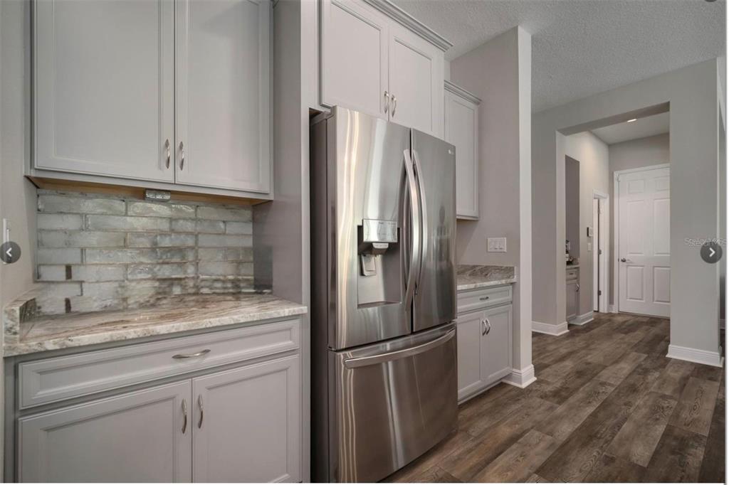 7004 Mainland Avenue Apollo Beach, FL 33572 - Photo 20 of 67 a kitchen with stainless steel appliances granite countertop a refrigerator and a sink