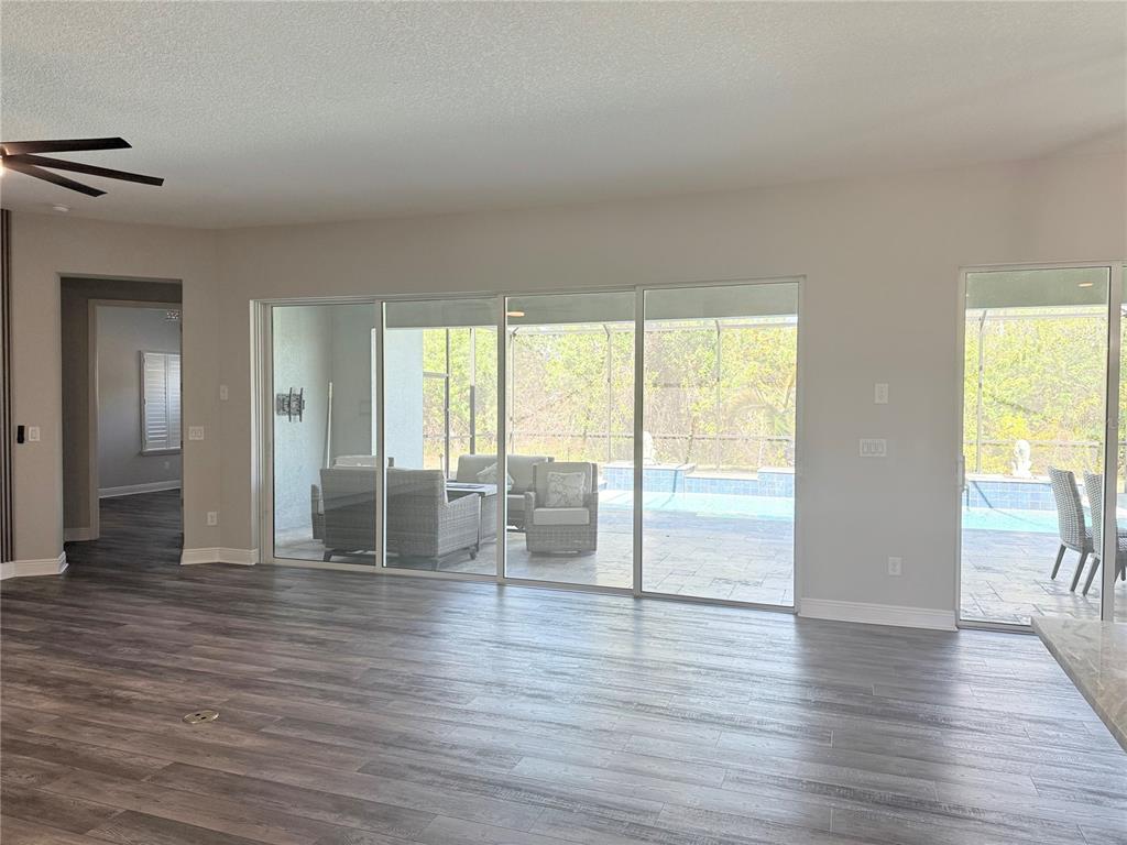 7004 Mainland Avenue Apollo Beach, FL 33572 - Photo 25 of 67 a view of an empty room with wooden floor and a window