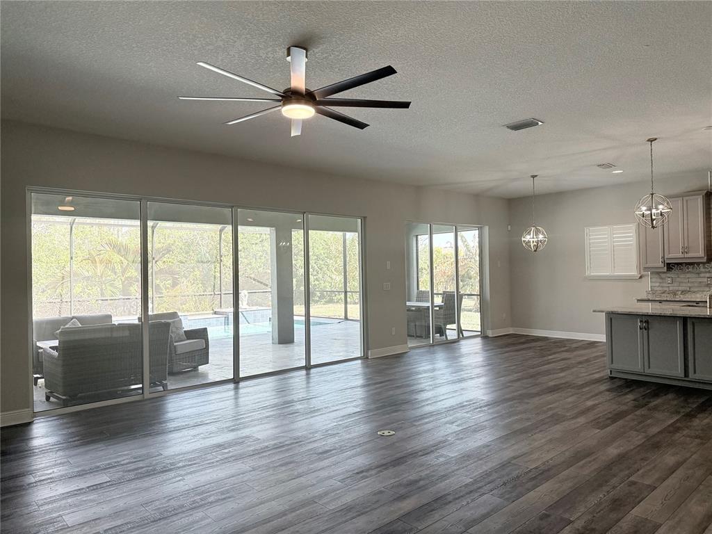 7004 Mainland Avenue Apollo Beach, FL 33572 - Photo 27 of 67 a view of an empty room with wooden floor and a window