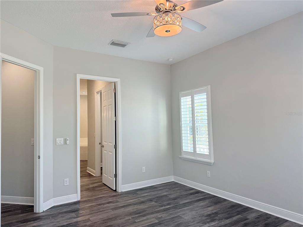 7004 Mainland Avenue Apollo Beach, FL 33572 - Photo 31 of 67 an empty room with wooden floor and windows