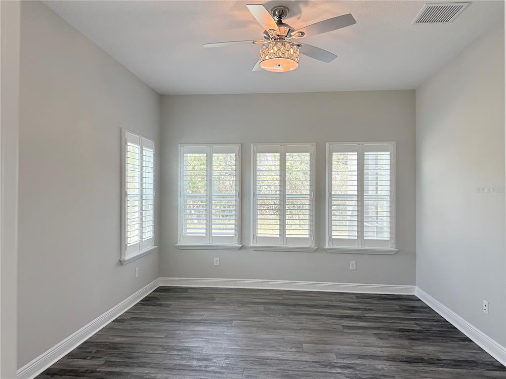 7004 Mainland Avenue Apollo Beach, FL 33572 - Photo 32 of 67 an empty room with wooden floor and window