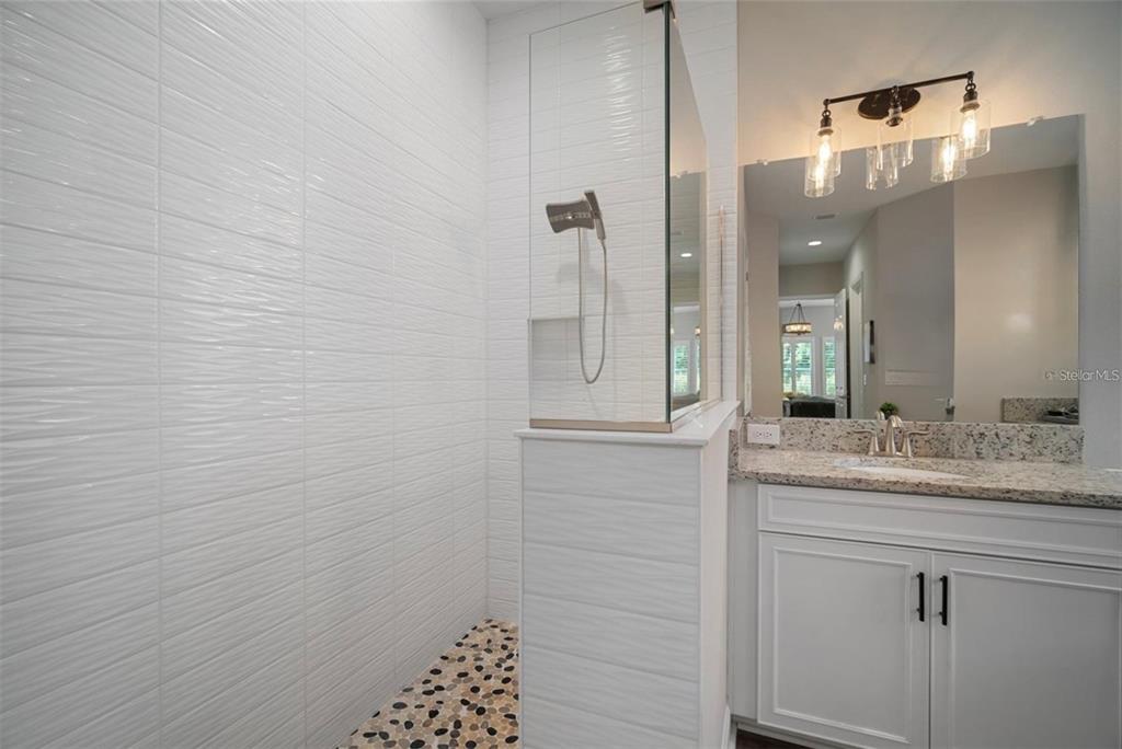 7004 Mainland Avenue Apollo Beach, FL 33572 - Photo 35 of 67 a bathroom with a sink and a mirror