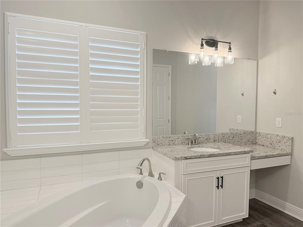 7004 Mainland Avenue Apollo Beach, FL 33572 - Photo 37 of 67 a bathroom with a granite countertop sink and a mirror