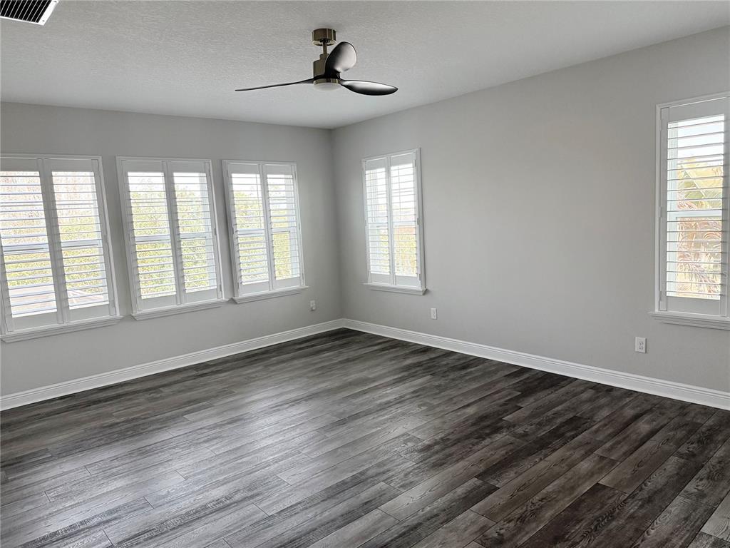 7004 Mainland Avenue Apollo Beach, FL 33572 - Photo 45 of 67 a view of an empty room with wooden floor and a window