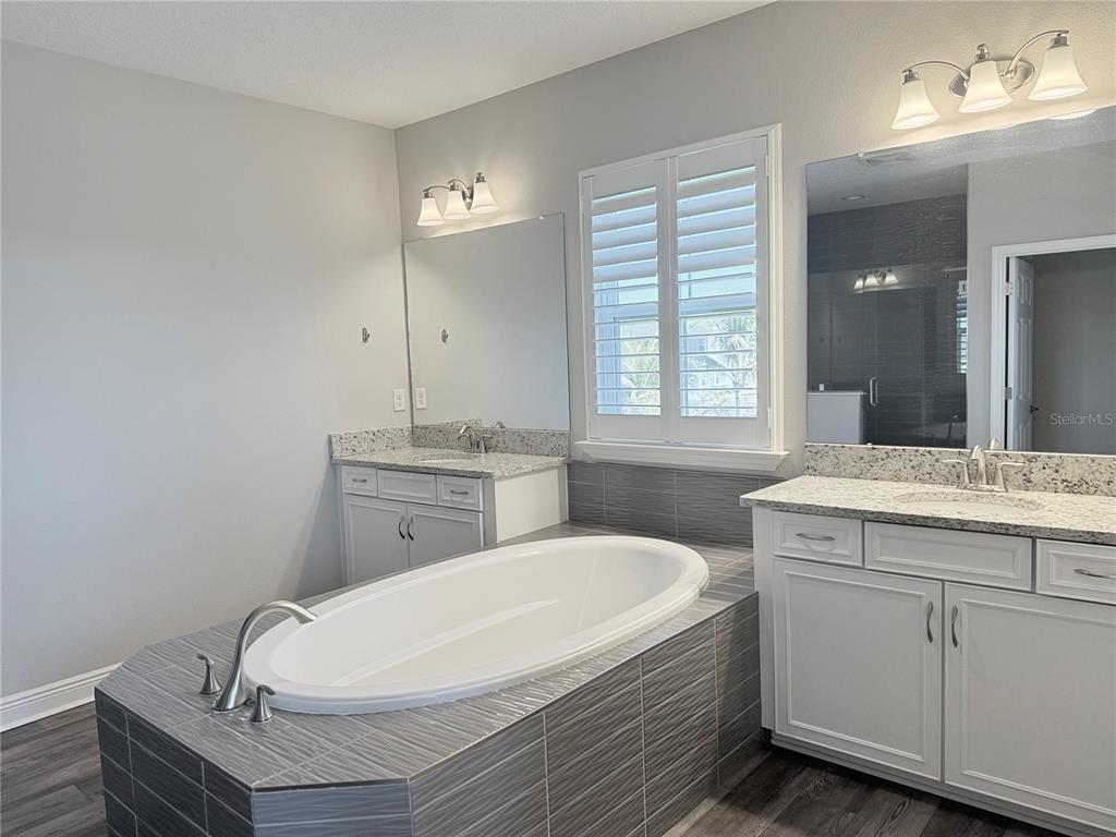 7004 Mainland Avenue Apollo Beach, FL 33572 - Photo 49 of 67 a bathroom with a granite countertop sink a toilet and mirror