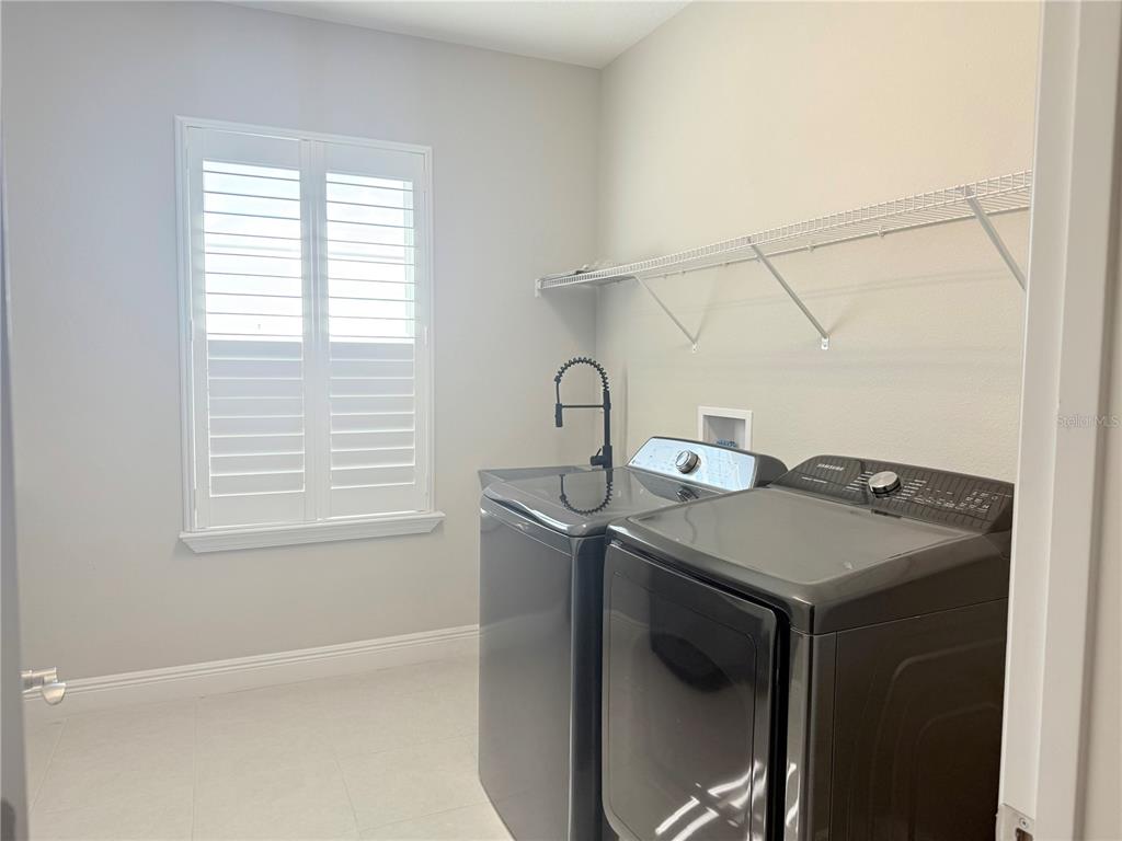 7004 Mainland Avenue Apollo Beach, FL 33572 - Photo 50 of 67 a utility room with dryer and window