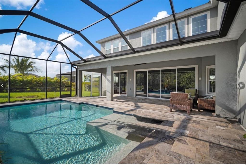 7004 Mainland Avenue Apollo Beach, FL 33572 - Photo 5 of 67 a swimming pool with outdoor seating and yard