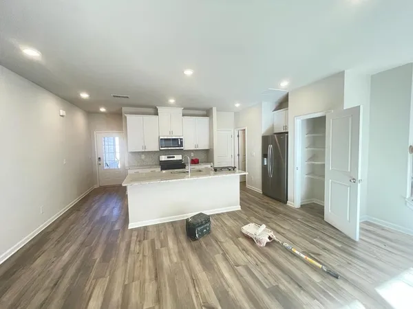 a view of kitchen with wooden floor and electronic appliances