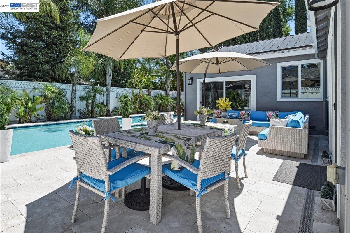 2861 Millbridge Place San Ramon, CA 94583 - Photo 44 of 58 a patio with a table and chairs under an umbrella