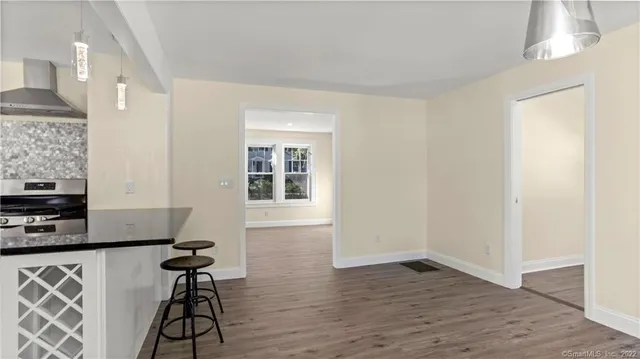 a view of a workspace with furniture and wooden floor