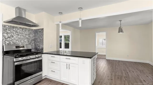 a kitchen with granite countertop a stove and a sink