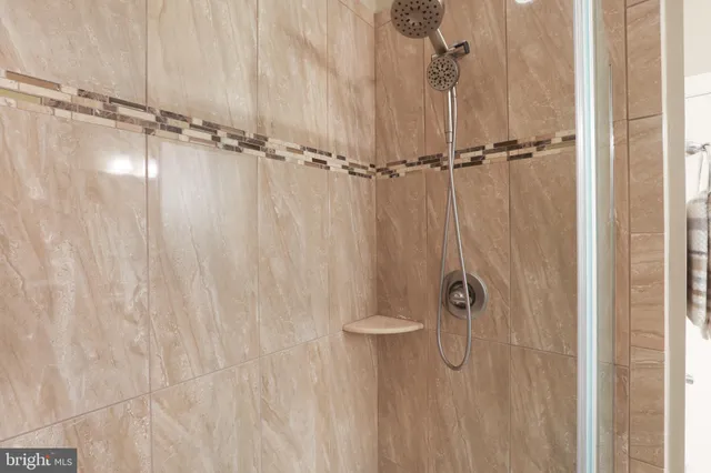 a spacious bedroom with a bed and a dresser