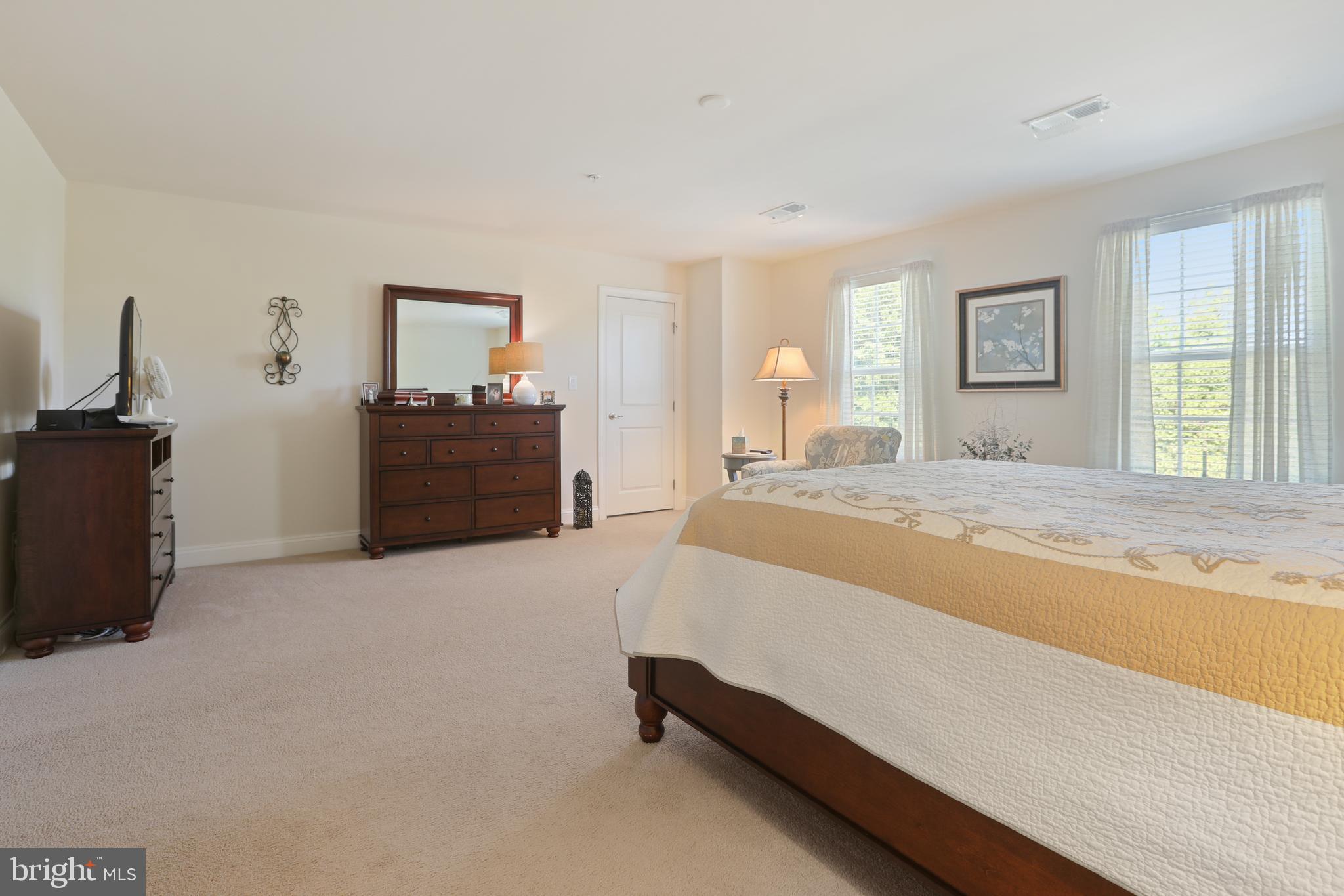 1843 Exton Drive, Unit 197 Fallston, MD 21047 - Photo 40 of 68 a spacious bedroom with a bed and a dresser