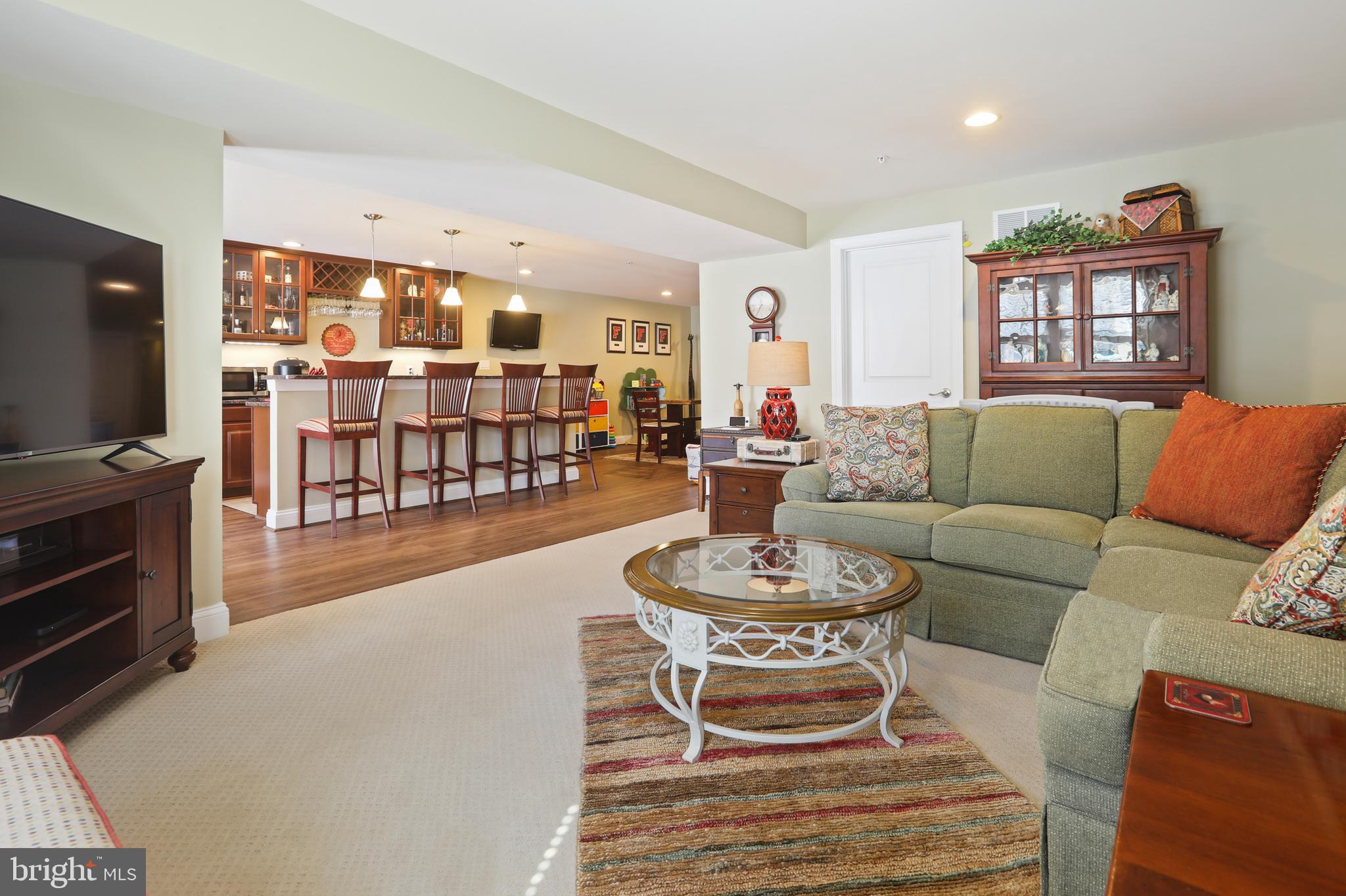 1843 Exton Drive, Unit 197 Fallston, MD 21047 - Photo 52 of 68 a living room with furniture a flat screen tv and a table