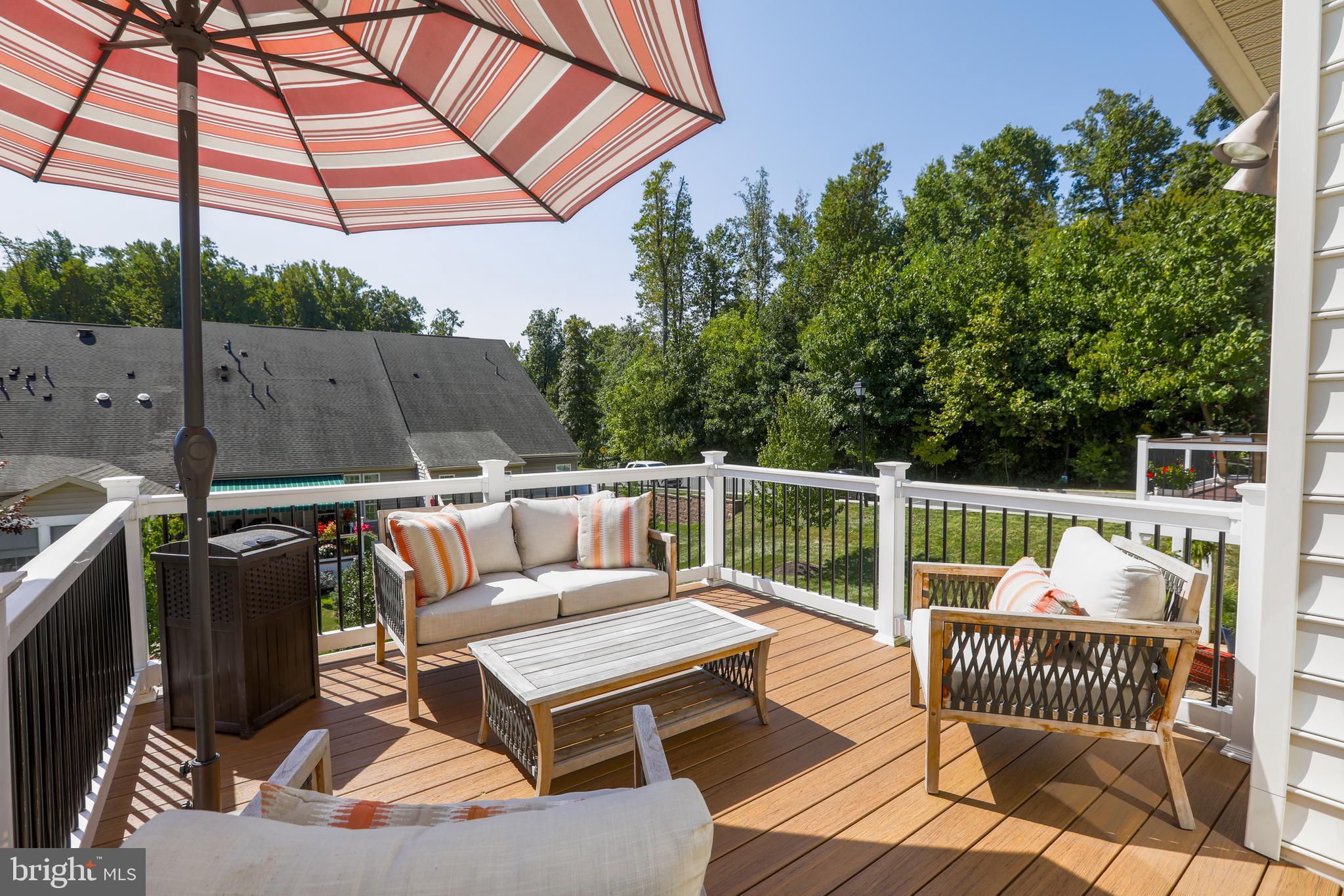1843 Exton Drive, Unit 197 Fallston, MD 21047 - Photo 56 of 68 a roof deck with a table and chairs under an umbrella