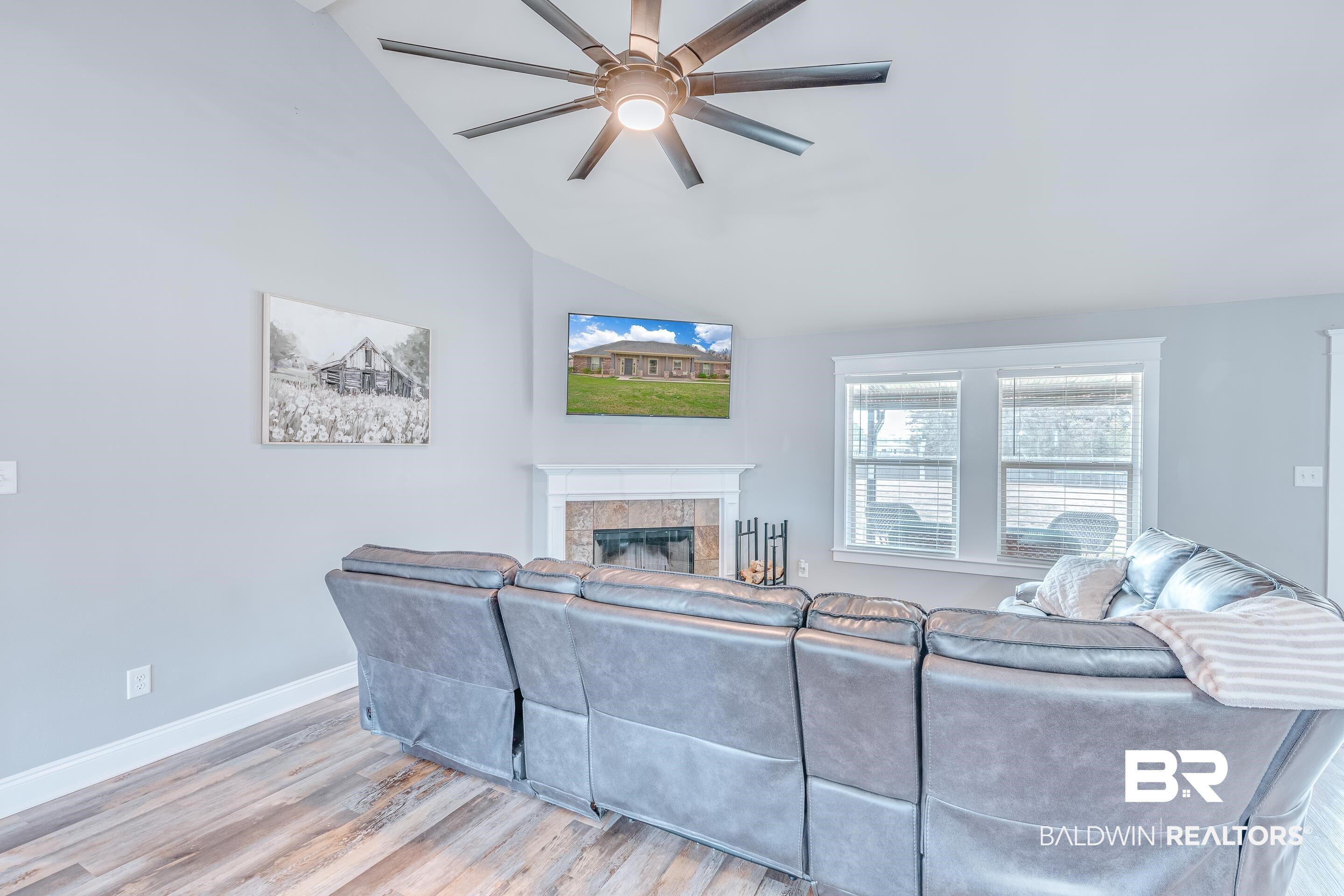 13235 Tom Gaston Road Mobile, AL 36695 - Photo 14 of 43 Living room with a tile fireplace, vaulted ceiling, ceiling fan, and light wood-type flooring
