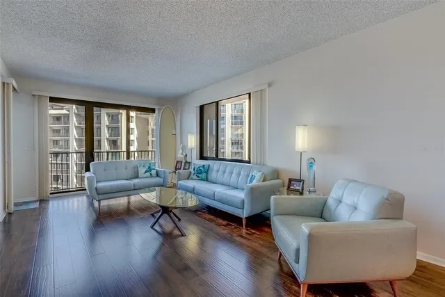 a living room with furniture and wooden floor