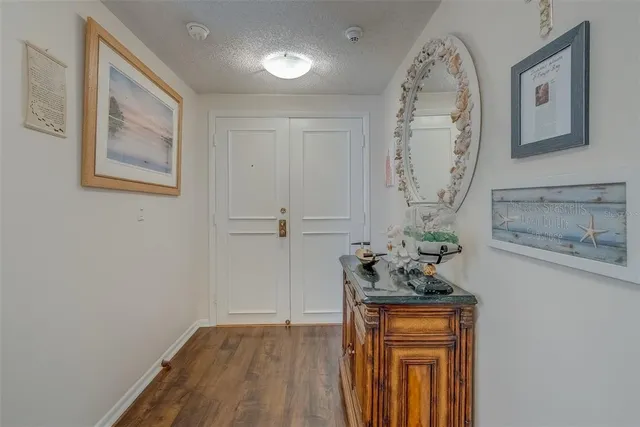 a room with painting on the wall and a wooden floor